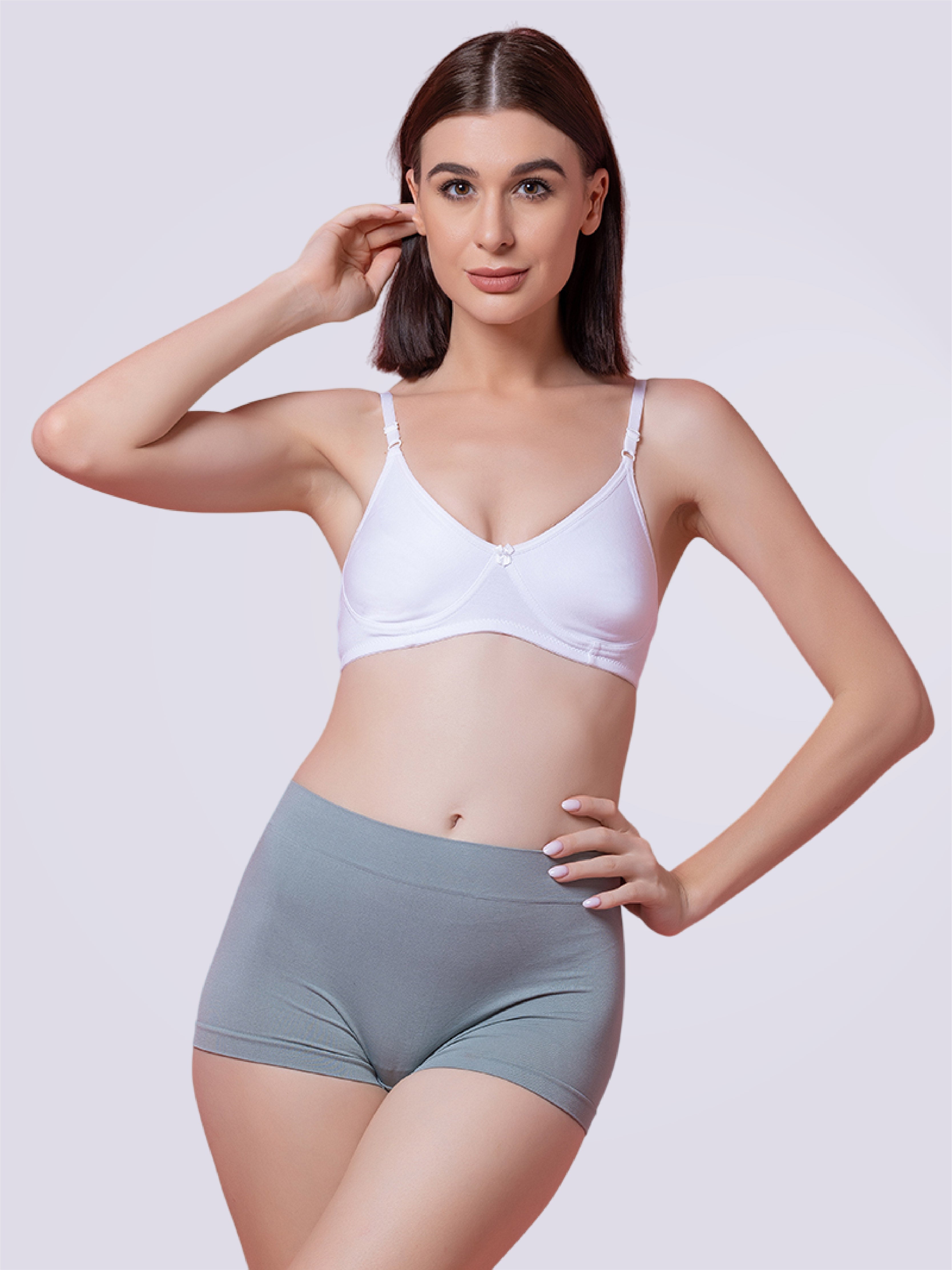 This image features a model showcasing the Sassy Shorty Full Coverage Mid Waist Panty in a skin tone color. The panty is designed to provide full coverage and is made from a breathable fabric blend of polyamide and spandex, ensuring both comfort and flexibility.